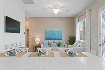 A living room with a couch and a ceiling fan